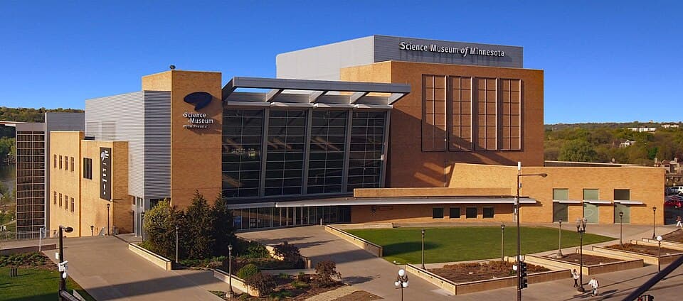 The Science Museum of Minnesota's main entrance on Kellogg Boulevard, with its glass facade and wide steps overlooking downtown Saint Paul